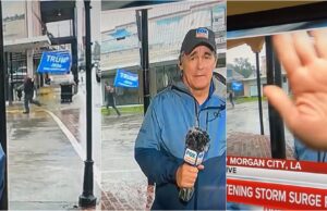 Triggered Weatherman Covers Camera as Man with Massive Trump Flag Runs in Background During Hurricane Broadcast | The Gateway Pundit