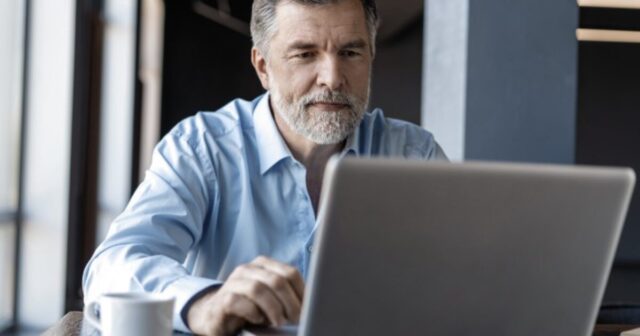 axos-man-with-computer-1200x630.jpg